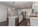 Bright kitchen with stainless appliances, white cabinets, and center island with pendant lighting at 6503 Georgia Oak Rd, Charlotte, NC 28269