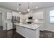 A modern kitchen featuring an island, stainless appliances, and ample cabinet space at 6503 Georgia Oak Rd, Charlotte, NC 28269