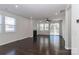 Open living room with fireplace, fan, and natural light at 6503 Georgia Oak Rd, Charlotte, NC 28269