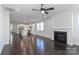 Spacious open-concept living room with fireplace, hardwood floors, and kitchen view at 6503 Georgia Oak Rd, Charlotte, NC 28269