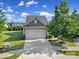 Gray house with two-car garage and landscaping at 730 Bushel Dr, Fort Mill, SC 29715