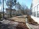 Landscaped backyard, stone retaining wall, and pathway at 9018 Kestral Ridge Dr, Charlotte, NC 28269