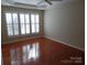 Hardwood floors and large windows in this bright bedroom at 9018 Kestral Ridge Dr, Charlotte, NC 28269