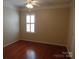 Well-lit bedroom with hardwood floors and window shutters at 9018 Kestral Ridge Dr, Charlotte, NC 28269