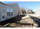 Side yard with grass and walkway to the home at 9018 Kestral Ridge Dr, Charlotte, NC 28269