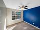 Bedroom with blue accent wall, carpet, and ceiling fan at 908 Coffee Tree Ln, Rock Hill, SC 29732