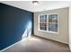 Well-lit bedroom with a large window and blue accent wall at 908 Coffee Tree Ln, Rock Hill, SC 29732