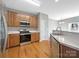 Kitchen boasts stainless steel appliances and wood cabinetry at 908 Coffee Tree Ln, Rock Hill, SC 29732