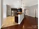 Modern kitchen with dark cabinetry, stainless steel appliances, and an island at 9140 Carneros Creek Rd, Charlotte, NC 28214