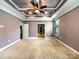 Large main bedroom with carpeted floors and tray ceilings at 9140 Carneros Creek Rd, Charlotte, NC 28214