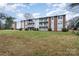 Brick apartment building with balconies and grassy area at 9325 Old Concord Rd # C, Charlotte, NC 28213