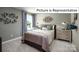 Cozy bedroom with a double bed, dresser, and unique wall art at 1002 Merganser Way, Indian Trail, NC 28079