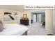 Spacious bedroom with a king-size bed and adjoining sitting area at 1002 Merganser Way, Indian Trail, NC 28079