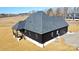 Rear elevation showcasing back deck and landscaping at 1008 Harrogate Dr, Bessemer City, NC 28016