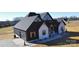 Rear view of the home showcasing the garage and landscaping at 1008 Harrogate Dr, Bessemer City, NC 28016