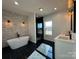 Spa-like bathroom with soaking tub, walk-in shower, and stone accent wall at 1008 Harrogate Dr, Bessemer City, NC 28016