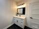 Bathroom vanity with quartz countertop and black tile floor at 1008 Harrogate Dr, Bessemer City, NC 28016