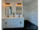 Double vanity bathroom with modern fixtures and dark tile floors at 1008 Harrogate Dr, Bessemer City, NC 28016