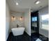 Spa-like bathroom with soaking tub, walk-in shower, and stone accent wall at 1008 Harrogate Dr, Bessemer City, NC 28016