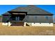 Home's rear elevation, highlighting the deck and yard at 1008 Harrogate Dr, Bessemer City, NC 28016