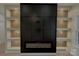 Modern fireplace with built-in shelving and unique lighting at 1008 Harrogate Dr, Bessemer City, NC 28016