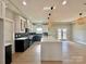 Open concept kitchen with island, stainless steel appliances, and dark cabinets at 1008 Harrogate Dr, Bessemer City, NC 28016