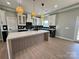 Modern kitchen with white and dark cabinets, large island, and stylish lighting at 1008 Harrogate Dr, Bessemer City, NC 28016