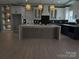 Modern kitchen with white and dark cabinets, large island, and stylish lighting at 1008 Harrogate Dr, Bessemer City, NC 28016
