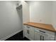 Laundry room with butcher block countertop and white cabinets at 1008 Harrogate Dr, Bessemer City, NC 28016