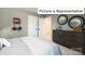 Bedroom with striped bedding and dark dresser at 1023 Merganser Way, Indian Trail, NC 28079
