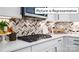 Modern kitchen detail with gas cooktop and herringbone tile backsplash at 1023 Merganser Way, Indian Trail, NC 28079