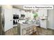 Stylish kitchen with an island, white cabinets, and herringbone backsplash at 1023 Merganser Way, Indian Trail, NC 28079