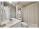 Well-maintained bathroom featuring a single sink vanity, white fixtures, and decorative wall accents at 11006 Knight Castle Dr, Charlotte, NC 28277