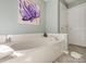 Inviting bathroom featuring a soaking tub, perfect for relaxation, with a soft color palette at 11006 Knight Castle Dr, Charlotte, NC 28277