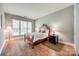 Well-lit bedroom features hardwood floors, decorative molding, and multiple windows for natural light at 11006 Knight Castle Dr, Charlotte, NC 28277