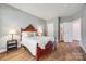 This bedroom features hardwood floors, neutral paint, and an ensuite bathroom at 11006 Knight Castle Dr, Charlotte, NC 28277