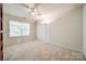 Empty bedroom with neutral carpet, ceiling fan, and large window at 11006 Knight Castle Dr, Charlotte, NC 28277