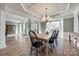Spacious dining room open to the foyer features hardwood floors, stylish lighting, and neutral wall color at 11006 Knight Castle Dr, Charlotte, NC 28277