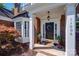 Inviting front entryway with a wreath on the door, decorative plants, and elegant architectural details at 11006 Knight Castle Dr, Charlotte, NC 28277