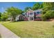 Charming brick front house with manicured lawn, mature trees, and a welcoming entrance exudes curb appeal at 11006 Knight Castle Dr, Charlotte, NC 28277