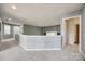 A view of a carpeted upstairs hallway with neutral paint and a small seating nook at 11006 Knight Castle Dr, Charlotte, NC 28277