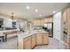 Bright kitchen showcases wood cabinetry, stainless steel appliances, a large island, and an open layout at 11006 Knight Castle Dr, Charlotte, NC 28277