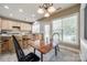 Cozy eat-in kitchen boasts natural wood cabinetry, stainless appliances, tile flooring, and great natural light at 11006 Knight Castle Dr, Charlotte, NC 28277