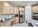 Kitchen features wood cabinets, granite countertops, stainless steel appliances, and an adjacent desk area at 11006 Knight Castle Dr, Charlotte, NC 28277