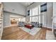 Spacious living room with large windows, hardwood floors, neutral decor, and an open layout to the kitchen at 11006 Knight Castle Dr, Charlotte, NC 28277