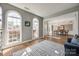 Bright living room featuring arched windows, hardwood floors, and an open layout to the dining area at 11006 Knight Castle Dr, Charlotte, NC 28277