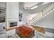 Inviting living room showcasing a fireplace, built-in shelving, staircase, and hardwood floors at 11006 Knight Castle Dr, Charlotte, NC 28277