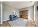 Inviting living room with hardwood floors, a comfortable armchair, and a decorative display cabinet at 11006 Knight Castle Dr, Charlotte, NC 28277
