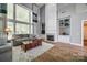 Bright living room with a soaring wall of windows, built-in shelving, fireplace, and hardwood floors at 11006 Knight Castle Dr, Charlotte, NC 28277