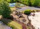 Aerial view of a community playground with multiple slides, picnic tables, and mature landscaping at 11006 Knight Castle Dr, Charlotte, NC 28277